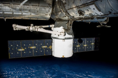 Meet the Dragon, a Space X free flying private cargo space craft. Here is docks with the ISS (Image: Space X)